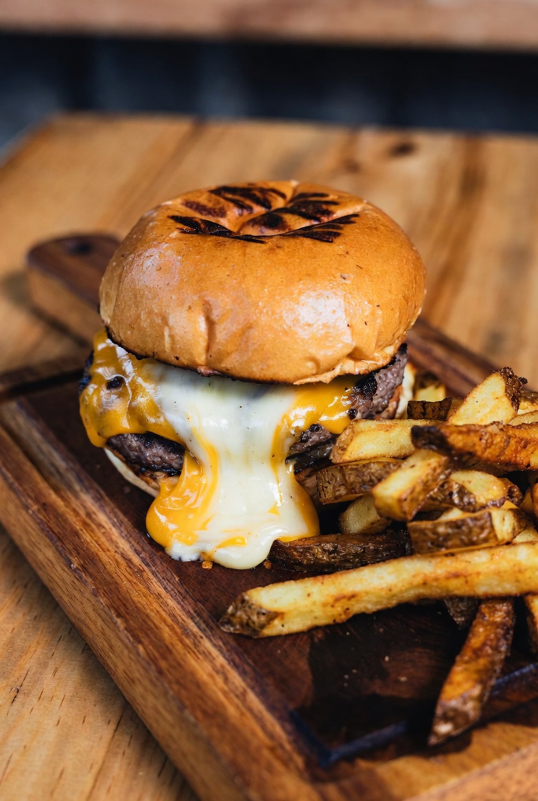 A cheeseburger and fries on a wooden board, photographed on its own — the Dish Only scan mode